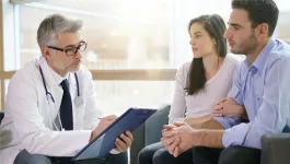 HCP consulting with a couple in a doctors office